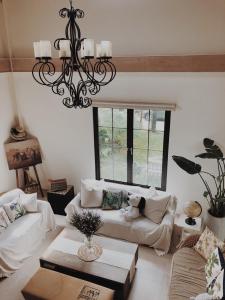 a living room with a couch and a chandelier at Artvilla Village in Xihu +3 photos
