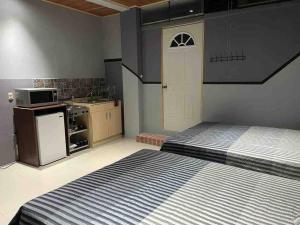 a small room with a bed and a kitchen at Hermoso Huehueloft2 con estacionamiento y wifi in Huehuetenango