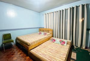 Postel nebo postele na pokoji v ubytování RedDoorz Hostel at MRC Residences Baguio