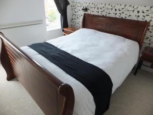 a bedroom with a bed with a black and white blanket at Grove Guest House in Nottingham