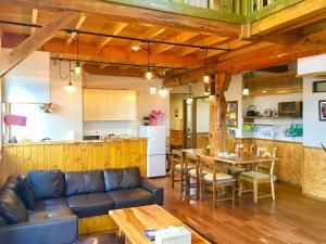 a living room with a couch and a table at Country Cottage Wakiaiai in Nakafurano