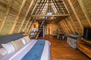 a bedroom with a large bed in a wooden house at Cerro Verde Mirador in Medellín
