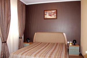 a bedroom with a bed and a picture on the wall at Sofia hotel apartments in Sofia