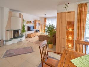 a living room with a table and a fireplace at Ferienhaus Binz - Apt. 01 in Binz