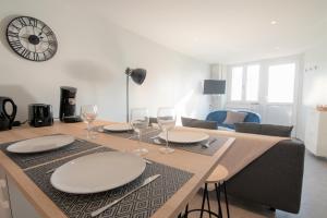 a dining table with plates and wine glasses on it at CABANA & Duplex - Cluny à 20 minutes in Saint-Bonnet-de-Joux +7 photos
