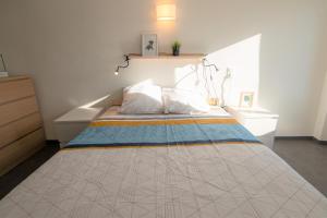 a large bed in a room with a bedspread on it at CABANA & Duplex - Cluny à 20 minutes 