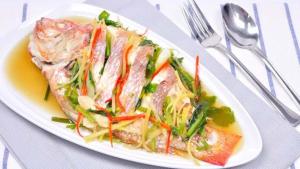 a white plate of food on a table at Sweet Time Bungalows in Koh Rong Sanloem