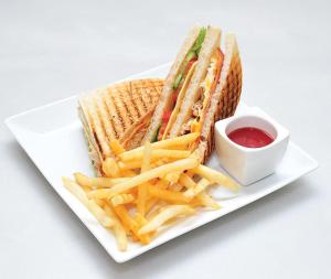 a sandwich and french fries on a plate with ketchup at Sweet Time Bungalows in Koh Rong Sanloem