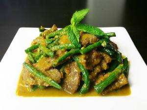 a plate of food with meat and green beans at Sweet Time Bungalows in Koh Rong Sanloem