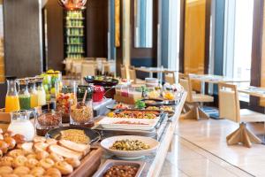a buffet table filled with lots of food at The Royal Park Hotel Iconic Tokyo Shiodome in Tokyo
