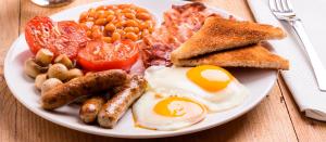 a plate of breakfast food with eggs sausage beans and toast at Sweet Time Bungalows in Koh Rong Sanloem