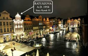 a view of a city street at night with buildings at STARY RYNEK Old Market Square PREMIUM Apartments & Restaurant Ratuszova AD 1954 room service & mini bar in Poznań