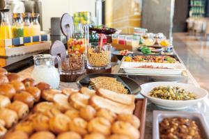 a buffet line with different types of food at The Royal Park Hotel Iconic Tokyo Shiodome in Tokyo
