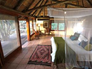 a bedroom with a large bed in a house at Lianshulu Lodge in Kongola