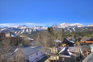 a town with snow covered mountains in the background at Longbranch in Breckenridge