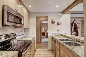a kitchen with a sink and a stove at Longbranch in Breckenridge