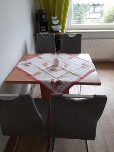 a dining room table with a map and chairs at Locken1 in Altenau