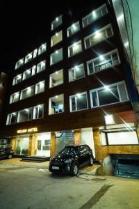 a car parked in front of a building at night at Welkin Hotel , HYDERABAD in Secunderabad
