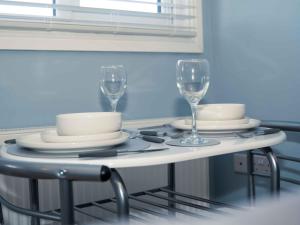a table with plates and wine glasses on it at Pass the Keys Newly Renovated 1 Bedroom Apartment Scarborough in Scarborough