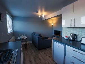 a kitchen and living room with a couch and a table at Pass the Keys Newly Renovated 1 Bedroom Apartment Scarborough in Scarborough