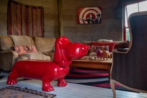 a red statue of a red dog in a living room at Fairview Estates in Fouriesburg