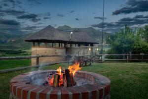 a fire pit in a yard with a gazebo at Fairview Estates in Fouriesburg