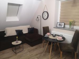 a living room with a couch and a table at Apartament Kala in Nysa