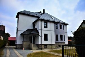 a white house with a black roof at Vila Quantum Bohemia in Vyšší Brod