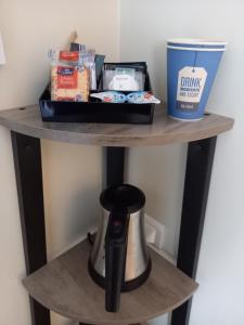 a shelf with a coffee maker and a container on it at Kyriad Nîmes Ouest A9 in Nîmes