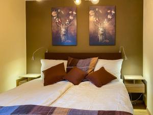 a bedroom with a bed with two deer paintings on the wall at Ferienhaus Frühlingstraße in Sonthofen
