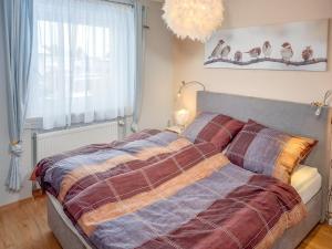 a large bed in a bedroom with a large window at Ferienhaus Frühlingstraße in Sonthofen +6 photos