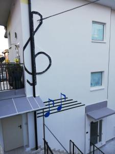 a metal sign on the side of a building at Wind in Nago-Torbole