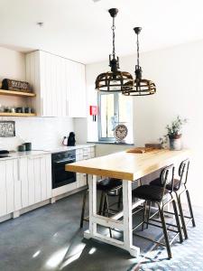 a kitchen with a wooden table and chairs at Charming Design House in Montijo, Casa 41 in Montijo