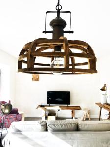 una gran lámpara de araña en la sala de estar con sofá en Charming Design House in Montijo, Casa 41 en Montijo