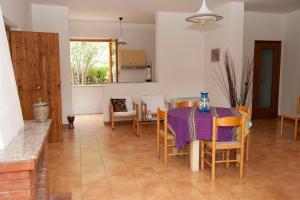a kitchen and dining room with a table and chairs at Elena Residence in Torchiara