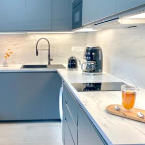 a kitchen with a glass of juice on a counter at HOSSEGOR Plage & Golf in Hossegor +23 photos