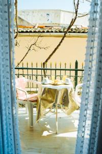 einen Tisch und Stühle mit einem Teller drauf in der Unterkunft Frida Apartments in Benitses