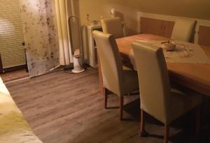 una sala da pranzo con tavolo e sedie in legno di Ferienwohnung Nähe Boltenhagen a Arpshagen