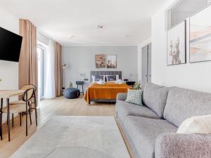 a living room with a couch and a bed at Limehome Münster Von-Steuben-Str - Digital Access in Münster