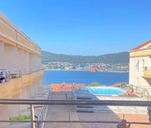 a view of the water from a balcony of a building at Apartamentos turísticos CHUS 2 in Corcubión
