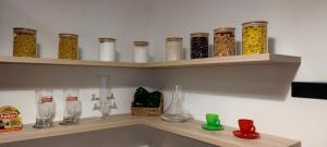 a shelf filled with lots of different types of glassware at Skackavá apartmán v centre Banskej Bystrice, 24h self check-in in Banská Bystrica