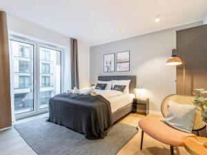 a bedroom with a bed and a large window at Limehome Münster Von-Steuben-Str - Digital Access in Münster