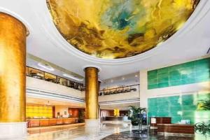 a lobby with a large painting on the ceiling at Ramada Plaza Pudong Shanghai in Shanghai