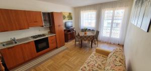 a kitchen with a couch and a table in a room at Angy Central Apartament in Aosta