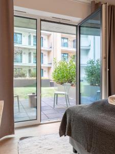 a bedroom with a bed and a sliding glass door at limehome Münster Von-Steuben-Str - Digital Access in Münster