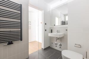 a bathroom with a toilet and a sink at Limehome Münster Von-Steuben-Str - Digital Access in Münster +42 photos