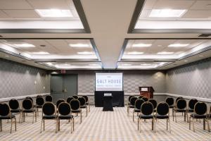 a conference room with chairs and a projection screen at Galt House Hotel, A Trademark Collection Hotel in Louisville