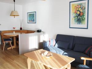 un soggiorno con divano e tavolo di Ferienhaus Nr 38, Kategorie Komfort, Feriendorf Hochbergle, Allgäu a Bichel