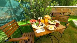 a table with plates of food on top of it at Akcapinar Korfez Butik Otel in Akyaka