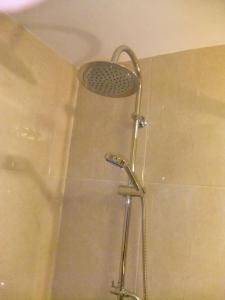 a shower with a shower head in a bathroom at Casa Mateus - Colares, Parque Natural Sintra Cascais in Sintra